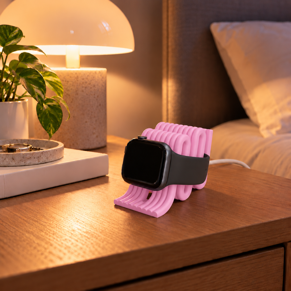 Apple Watch Charging Stand in Sakura pink on a bedside table